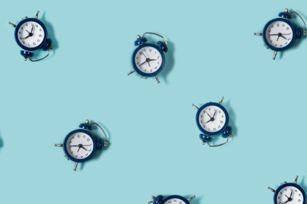 small blue clocks displaying time against a teal background